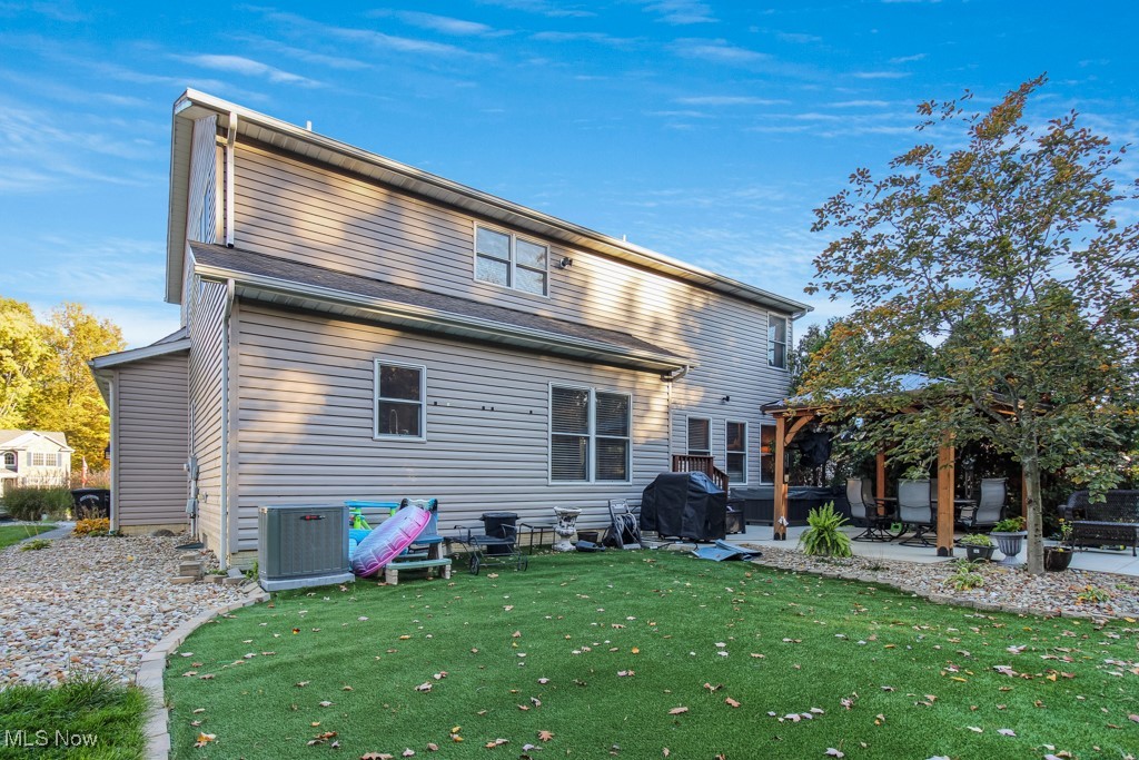 132 Timber Ridge Drive, Unit RDR Elyria, OH 44035 - Photo 41 of 41 Rear view of house featuring a patio area and a lawn