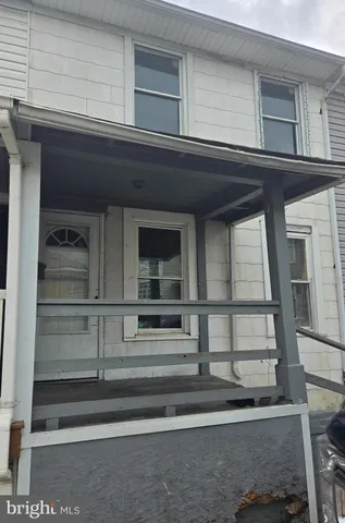 a view of house with wooden floor and windows