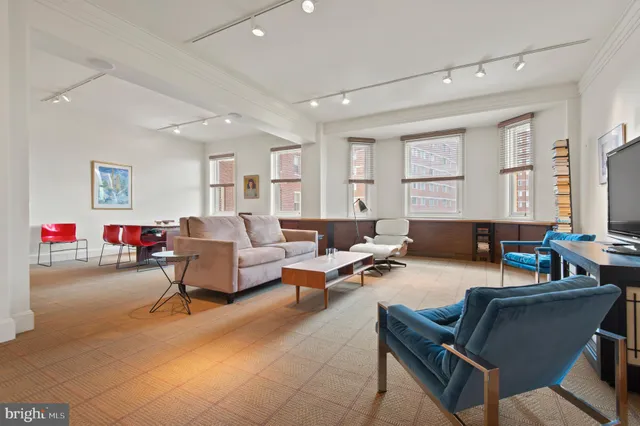 a living room with furniture a table and a window