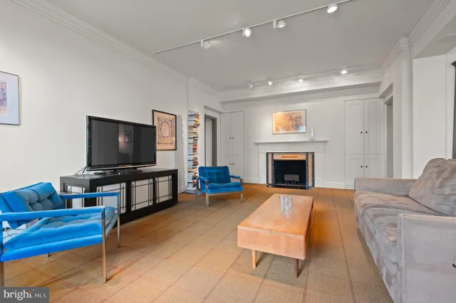a view of an empty room with window and fireplace