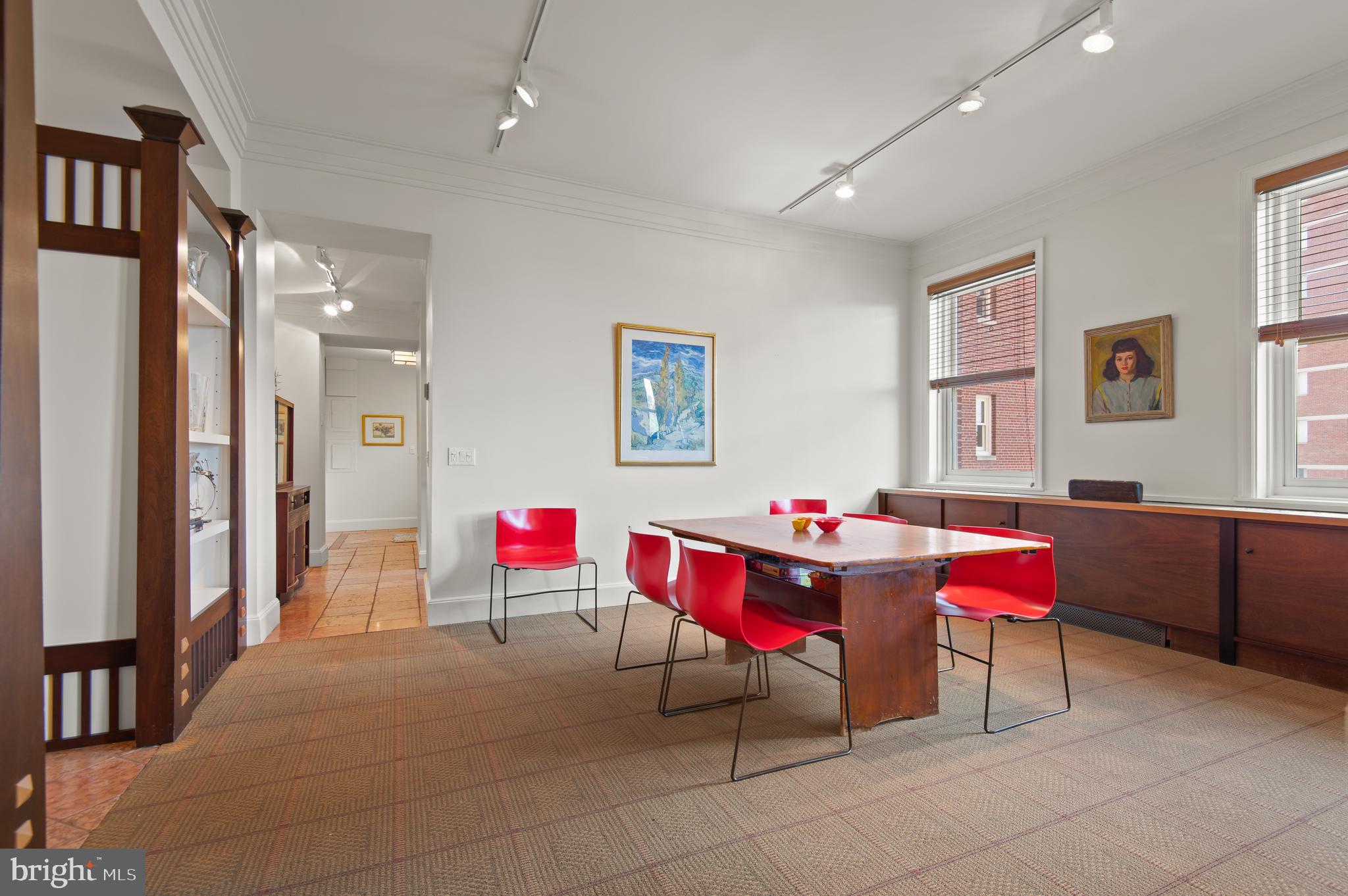 3908 North Charles Street, Unit 501 Baltimore, MD 21218 - Photo 16 of 54 a living room with blue walls furniture and a dining table