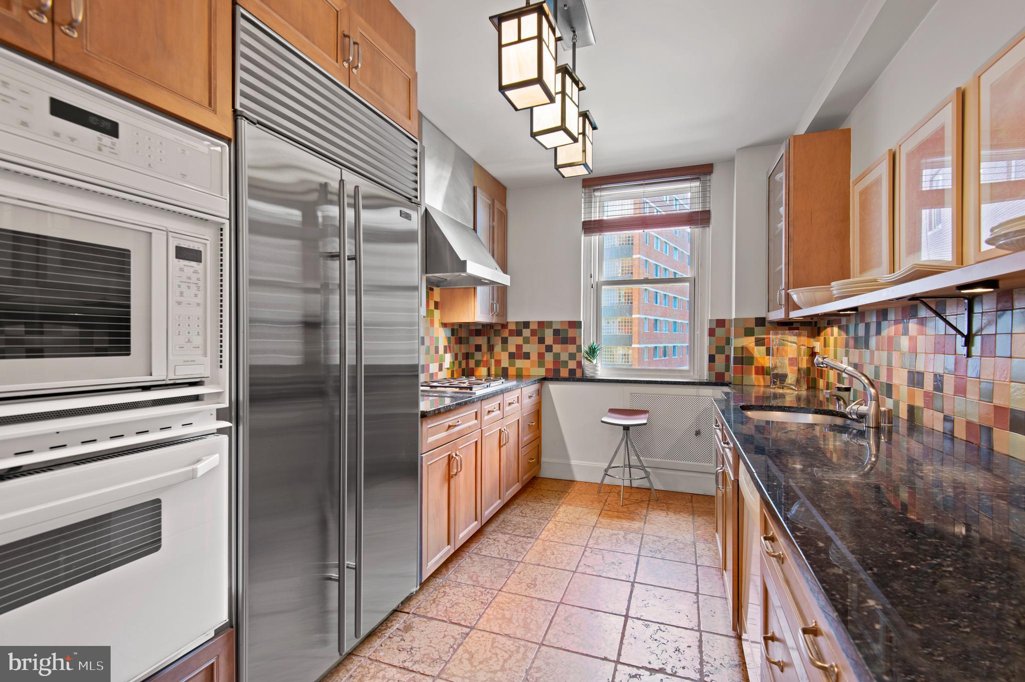 3908 North Charles Street, Unit 501 Baltimore, MD 21218 - Photo 19 of 54 a kitchen with stainless steel appliances granite countertop a stove and cabinets