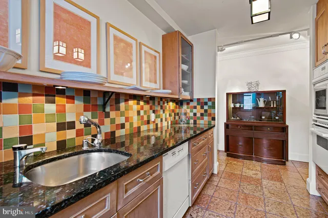 a kitchen with granite countertop a sink and cabinets