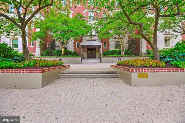 a view of a house with a garden and pathway