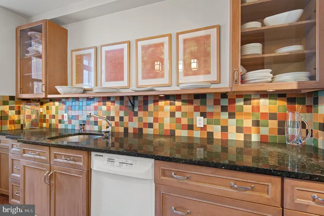 a kitchen with granite countertop a sink and cabinets