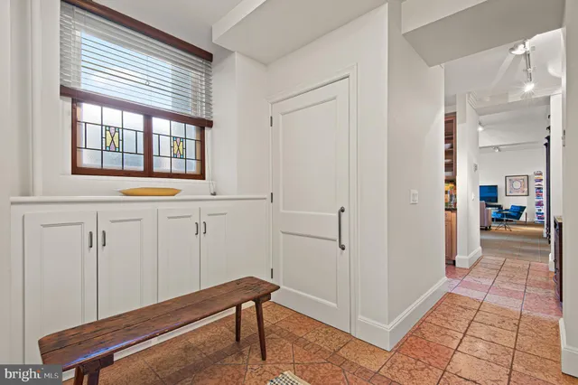 a spacious bedroom with a bed and glass door