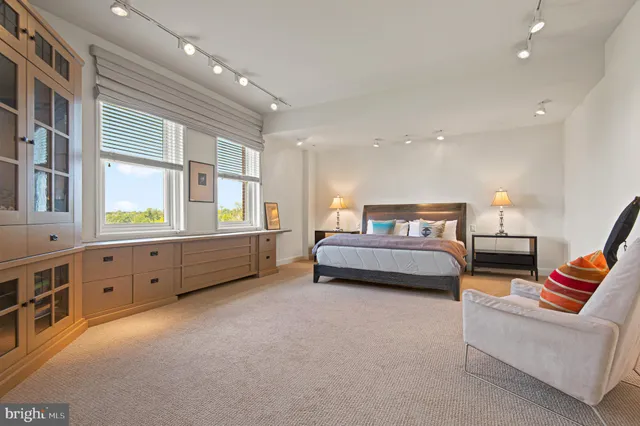 a spacious bathroom with a double vanity sink mirror and a bathtub