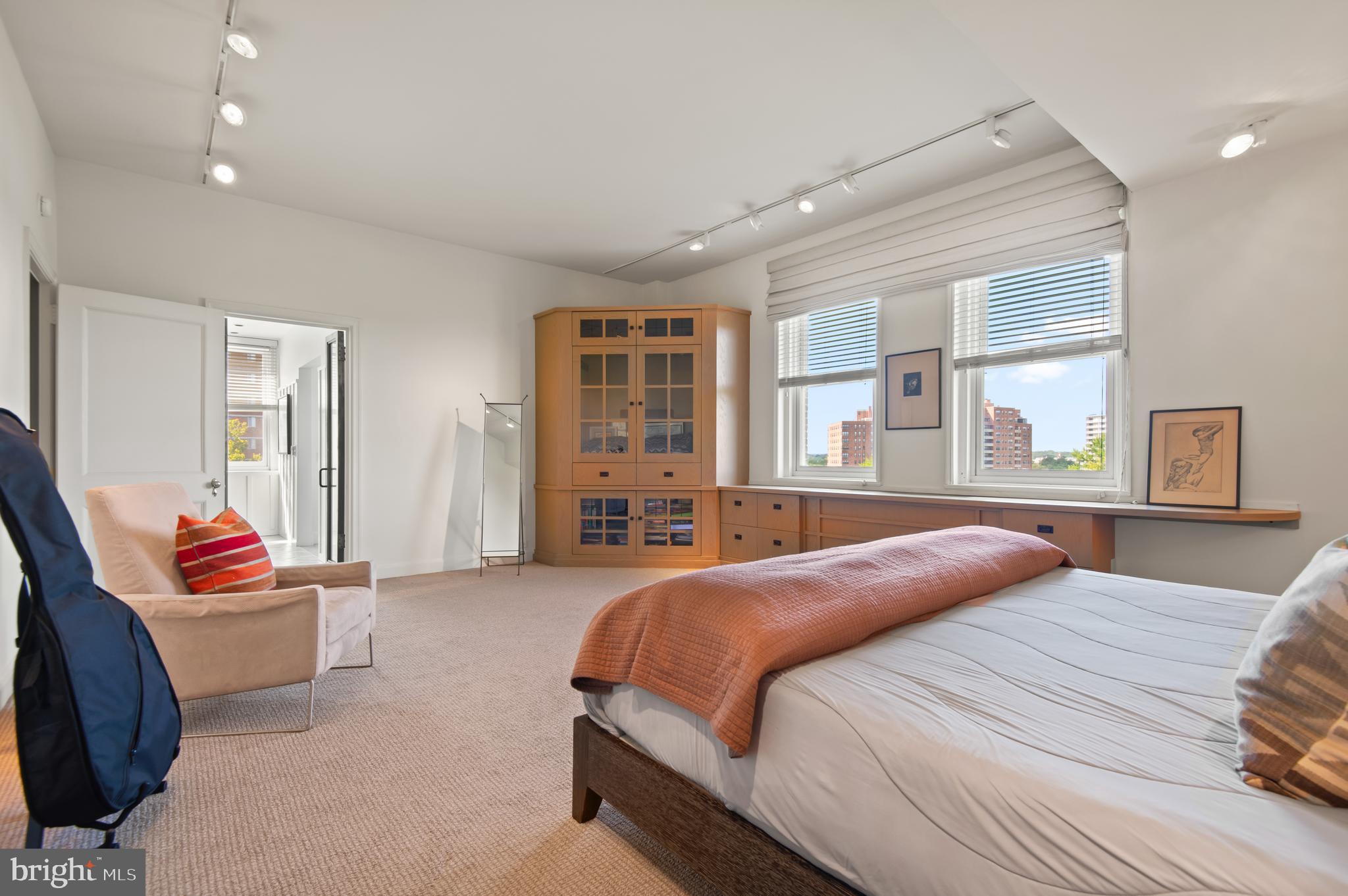 3908 North Charles Street, Unit 501 Baltimore, MD 21218 - Photo 28 of 54 a spacious bedroom with a bed and glass door