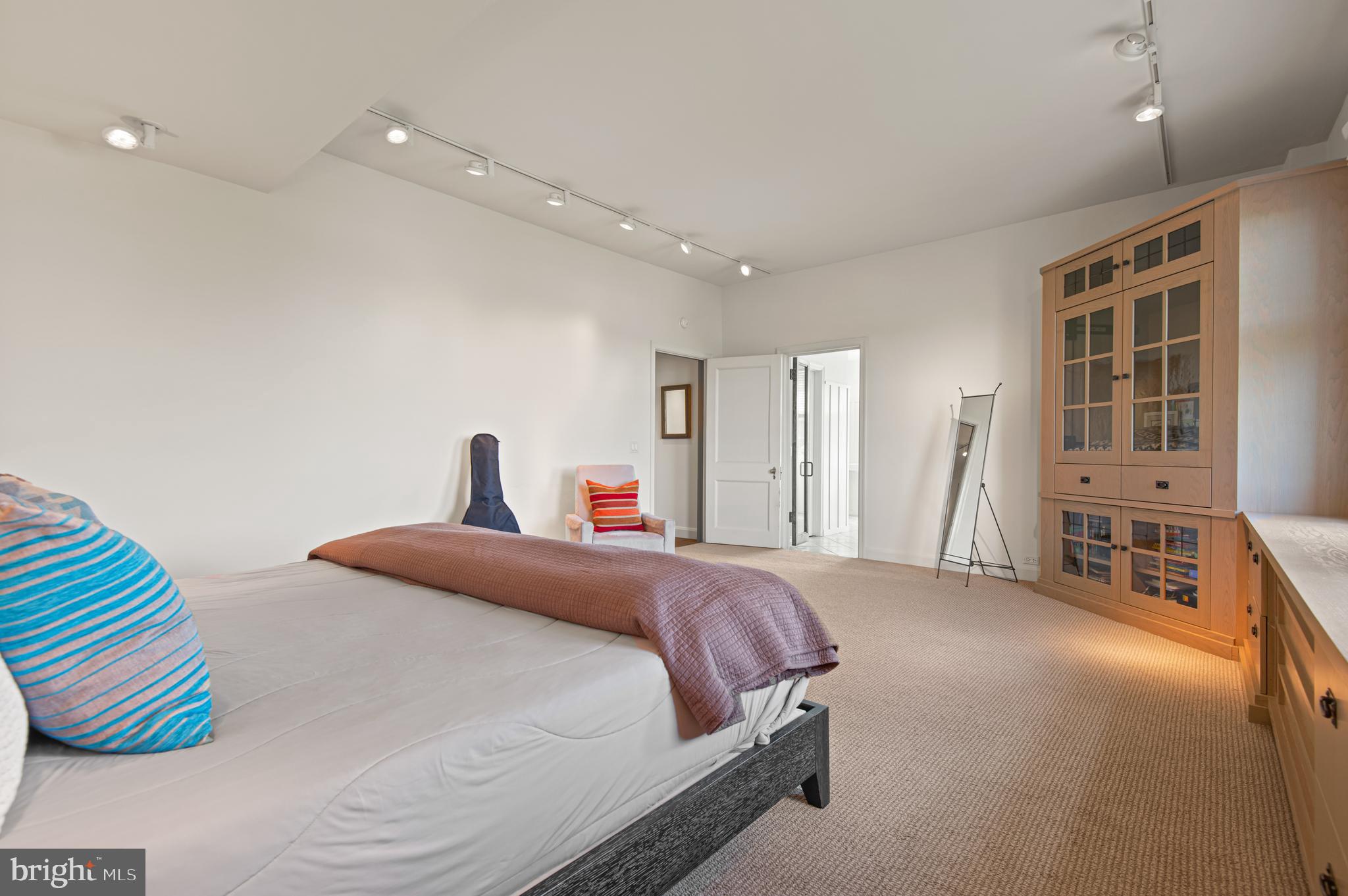 3908 North Charles Street, Unit 501 Baltimore, MD 21218 - Photo 29 of 54 a bedroom with a bed and a chandelier