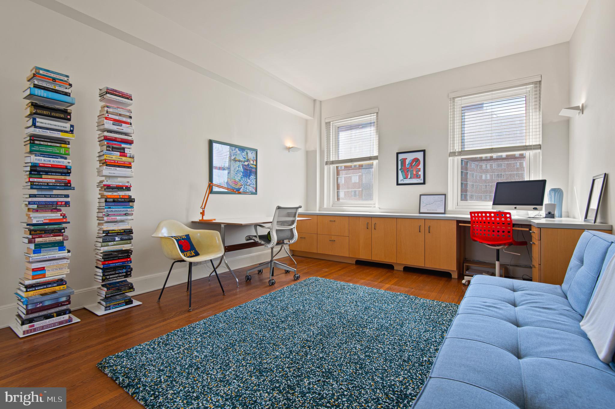3908 North Charles Street, Unit 501 Baltimore, MD 21218 - Photo 38 of 54 a bedroom with furniture and a book shelf