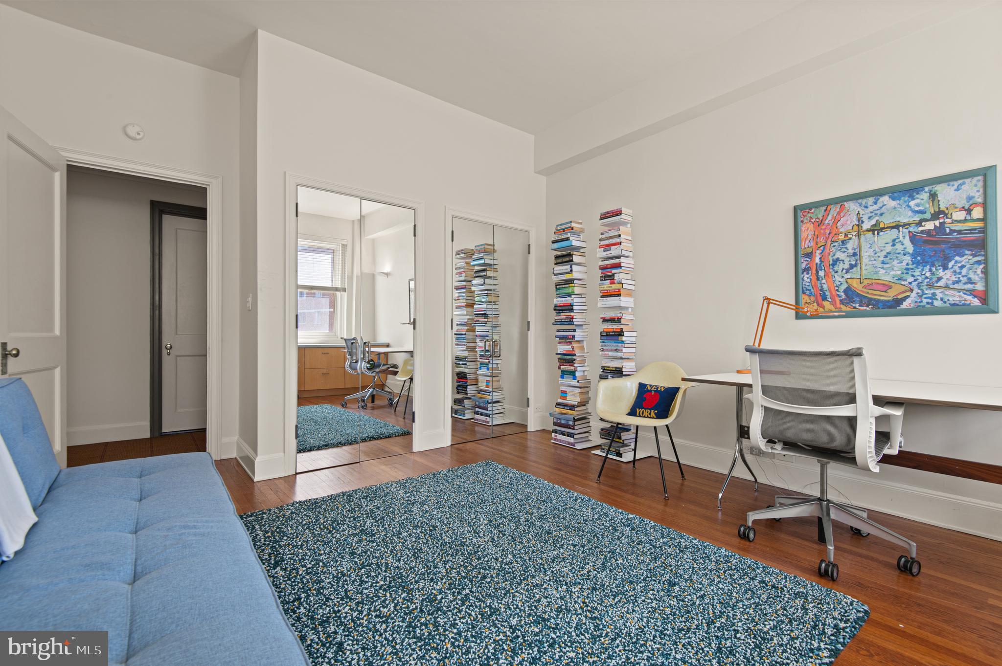 3908 North Charles Street, Unit 501 Baltimore, MD 21218 - Photo 39 of 54 a living room with furniture a rug and gym equipment
