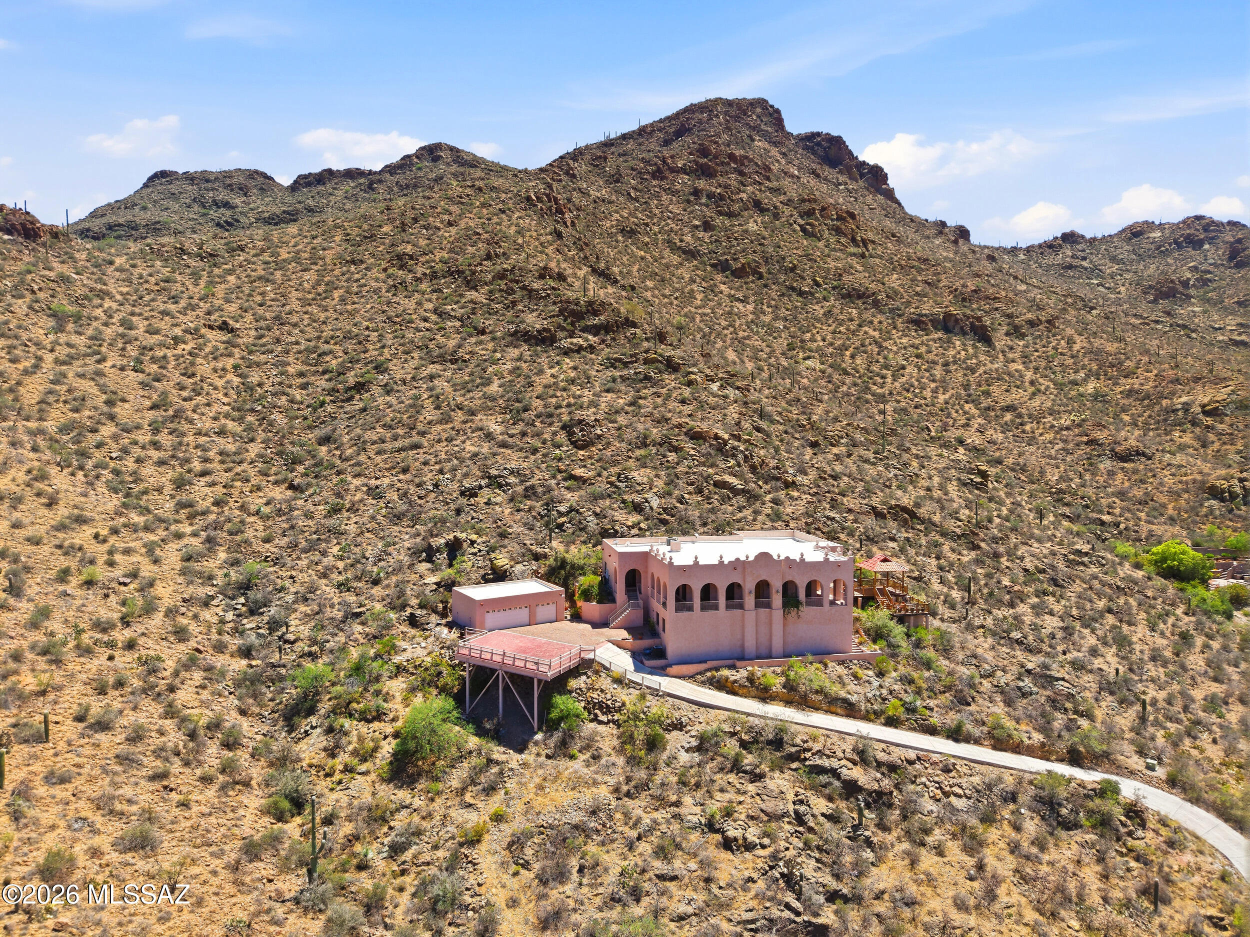 6331 West Trails End Road Tucson, AZ 85745 - Photo 36 of 41 a view of a house with a yard and a mountain view in back