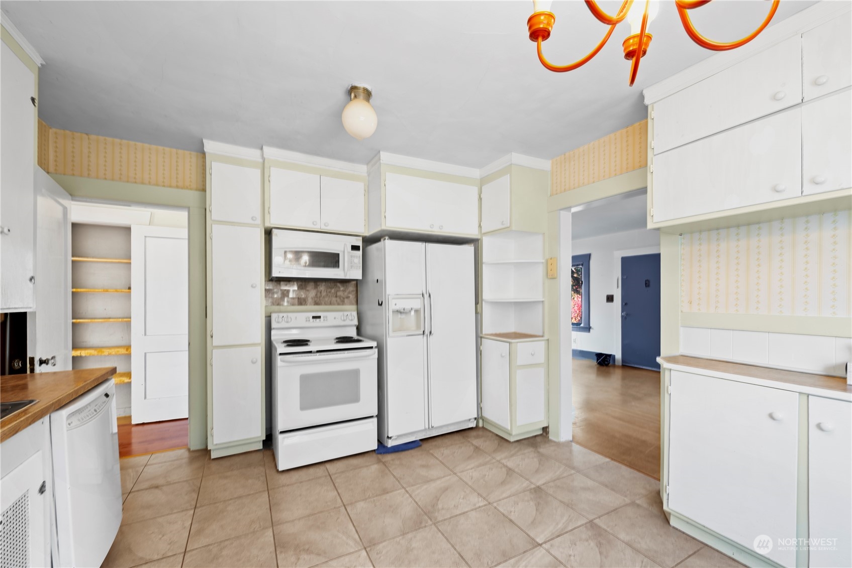 517 North 84th Street Seattle, WA 98103 - Photo 11 of 29 a kitchen with stainless steel appliances granite countertop a sink a stove a refrigerator and white cabinets