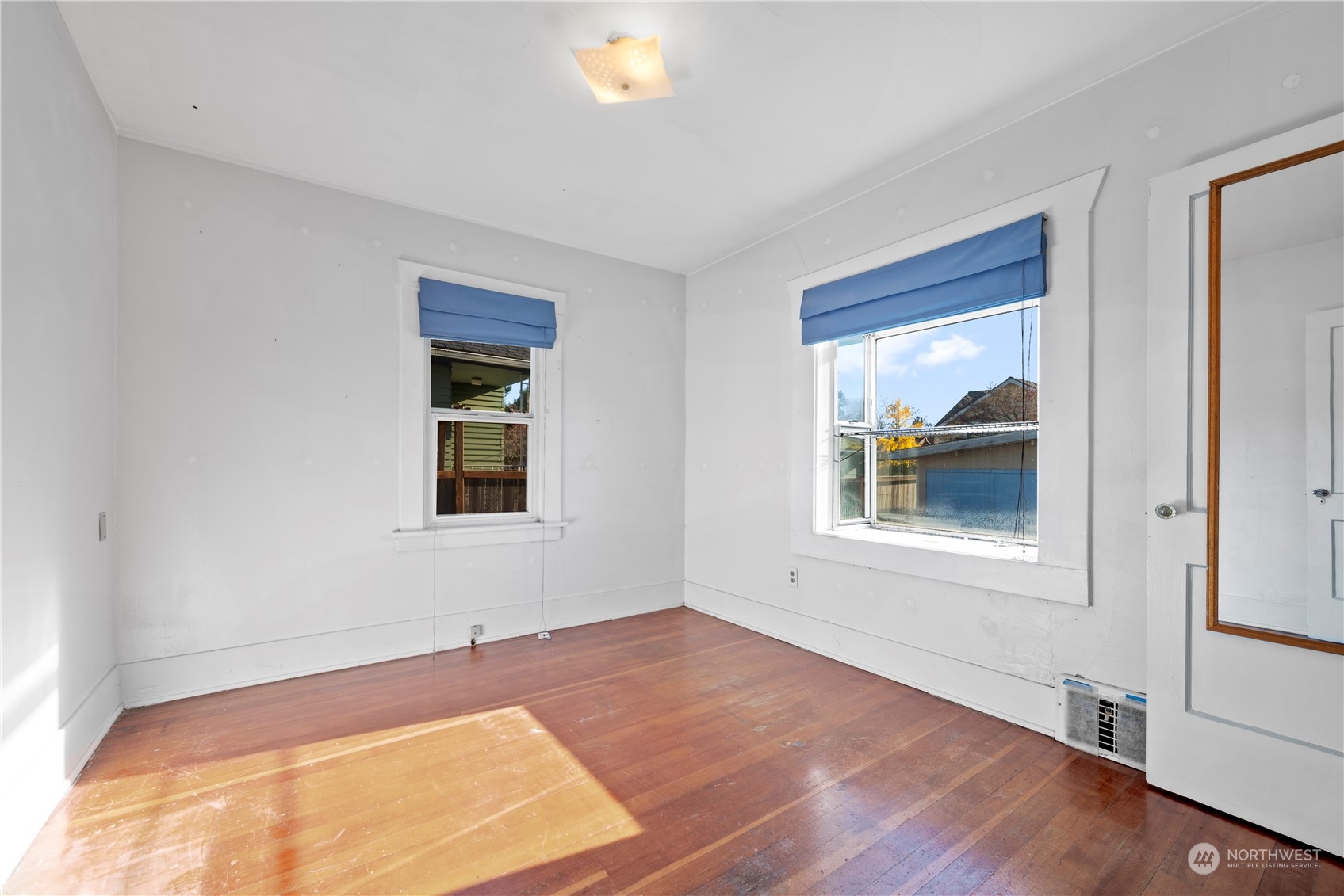 517 North 84th Street Seattle, WA 98103 - Photo 14 of 29 a view of an empty room with wooden floor and a window