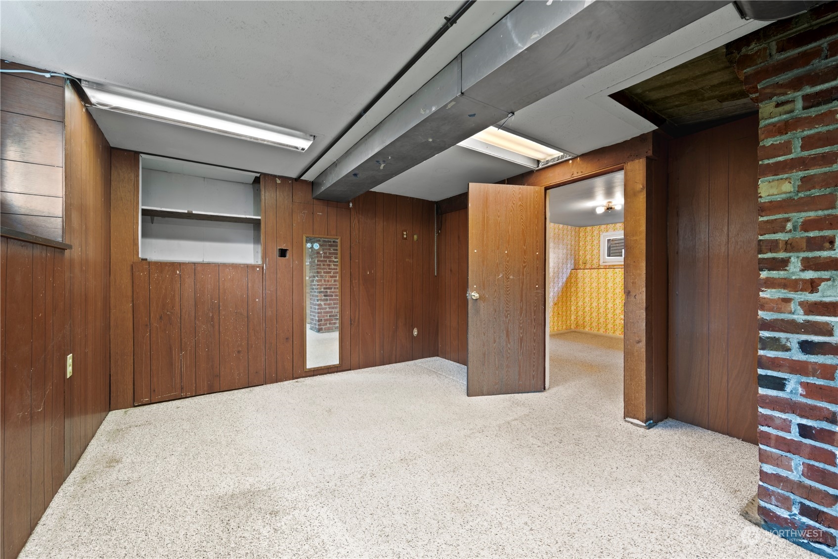 517 North 84th Street Seattle, WA 98103 - Photo 16 of 29 a view of a hallway with wooden shelves