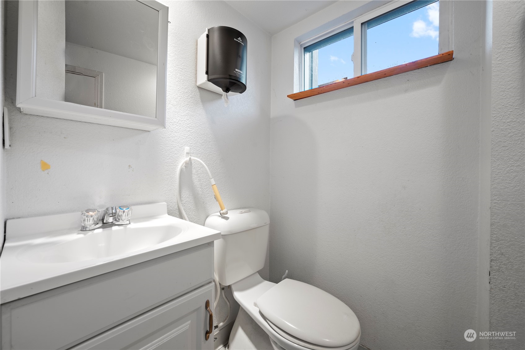 517 North 84th Street Seattle, WA 98103 - Photo 20 of 29 a bathroom with a toilet sink and mirror