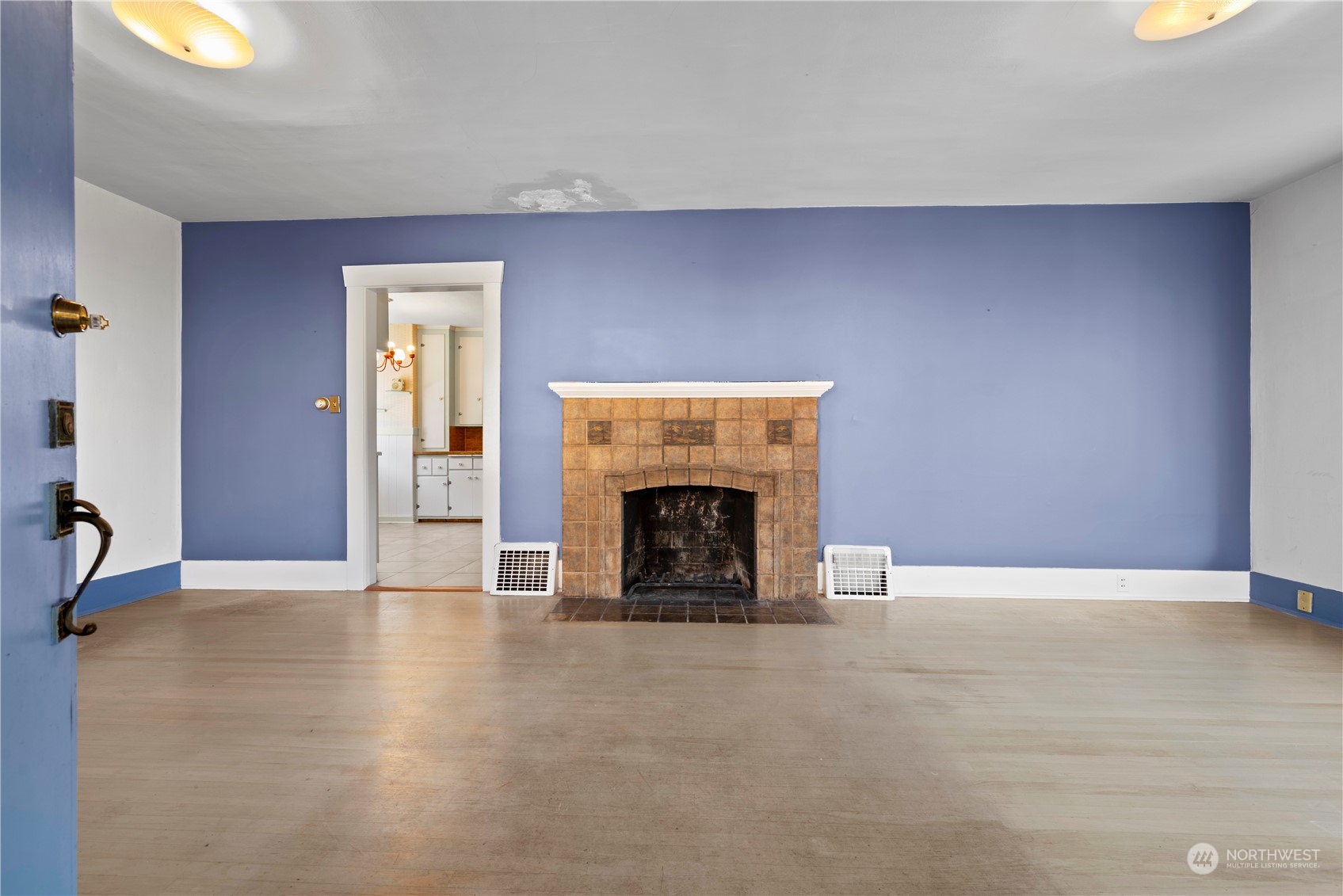 517 North 84th Street Seattle, WA 98103 - Photo 5 of 29 an empty room with windows and fireplace
