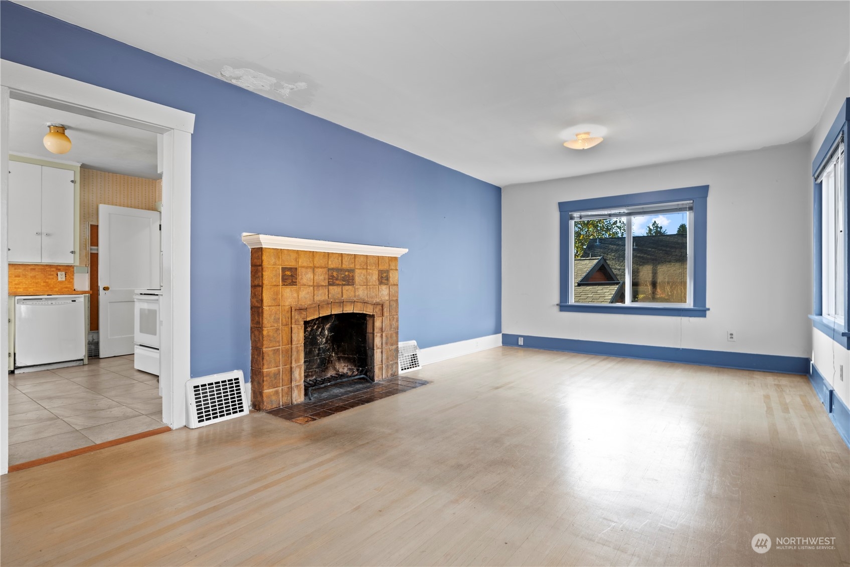 517 North 84th Street Seattle, WA 98103 - Photo 8 of 29 an empty room with windows and a fireplace