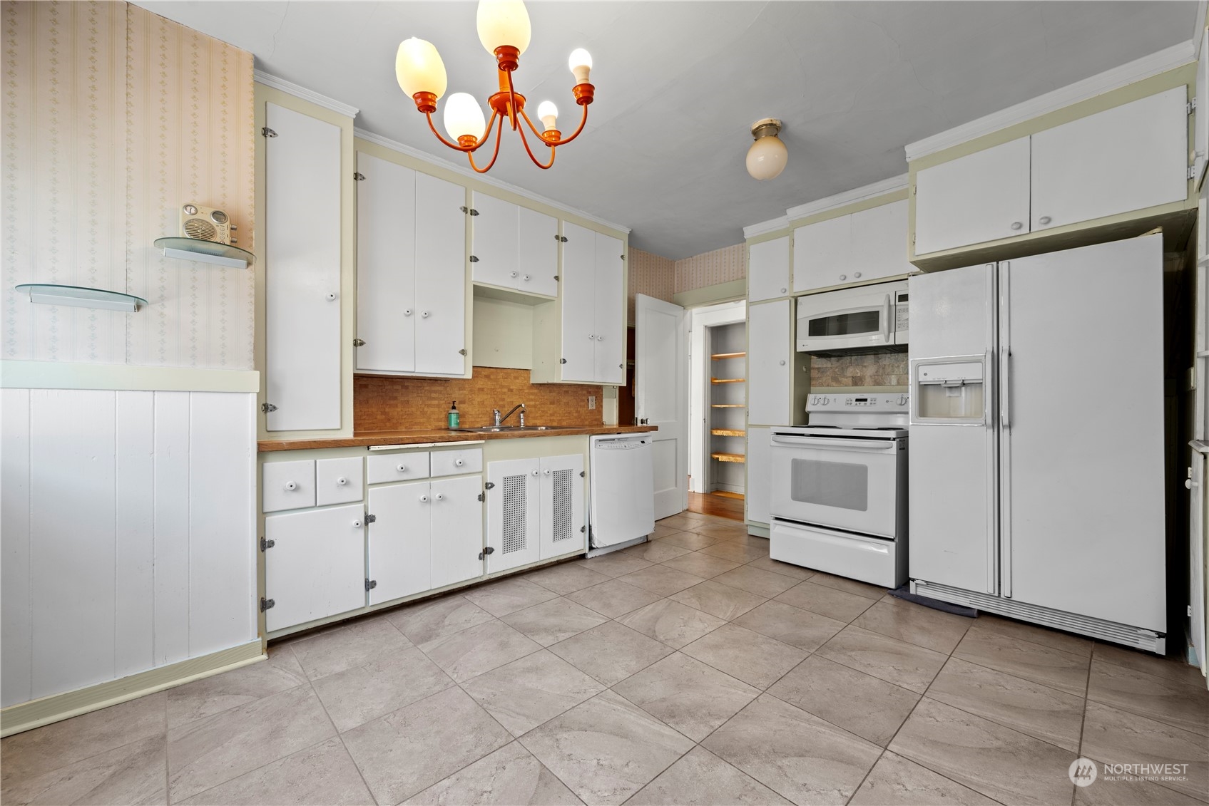 517 North 84th Street Seattle, WA 98103 - Photo 10 of 29 a kitchen with white cabinets and white appliances