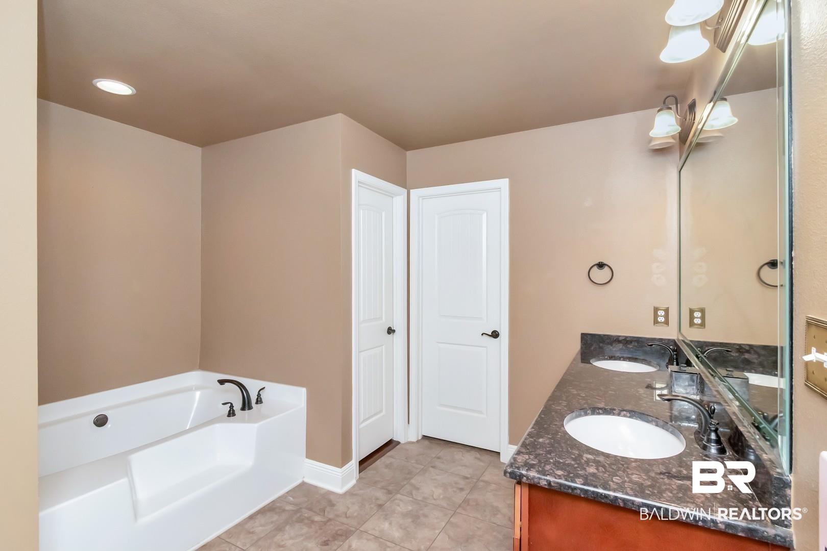 27890 Rileywood Drive Daphne, AL 36526 - Photo 24 of 49 Bathroom featuring a bath, tile patterned floors, a sink, and double vanity