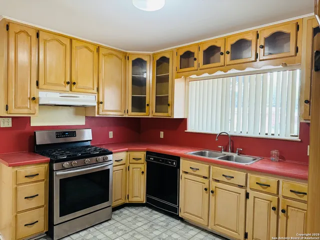 a kitchen with stainless steel appliances granite countertop a stove and a sink