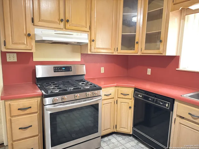 a kitchen with stainless steel appliances granite countertop a stove and a microwave
