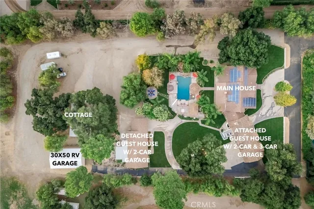 an aerial view of a house with a yard and garden