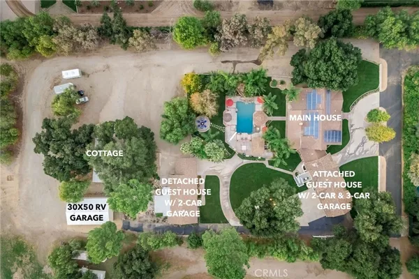 an aerial view of a house with a yard and garden