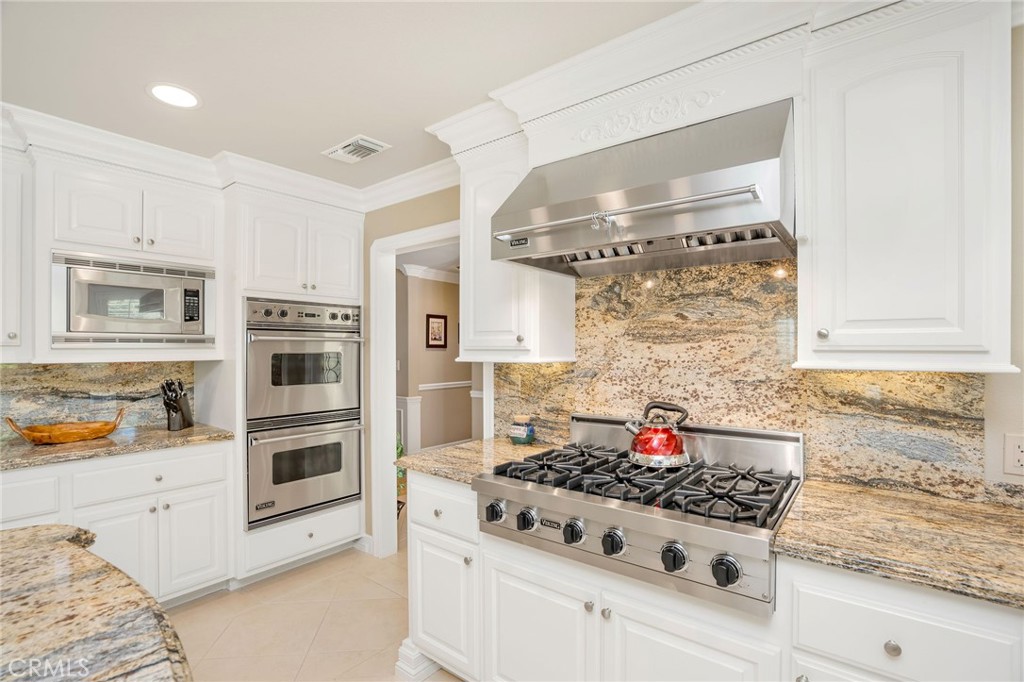 27767 Sand Canyon Road Canyon Country, CA 91387 - Photo 31 of 63 a kitchen with stainless steel appliances granite countertop a stove and cabinets