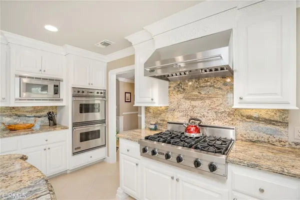 a dining room with furniture water view and a floor to ceiling window