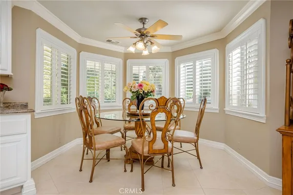 a dining room with furniture water view and a floor to ceiling window