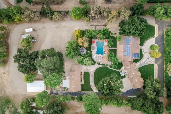 an aerial view of a house with a yard and lake view