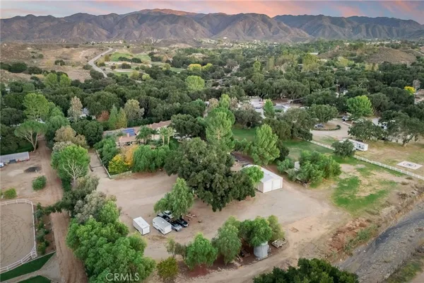 an aerial view of mountains residential house and green space