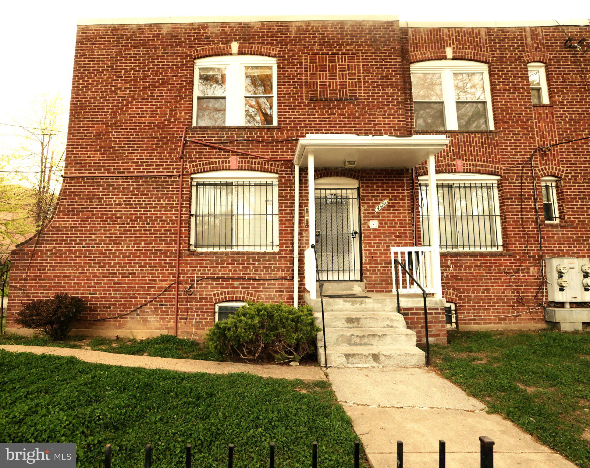 4329 Halley Terrace Southeast, Unit 3 Washington, DC 20032 - Photo 1 of 8 a front view of a house with garden