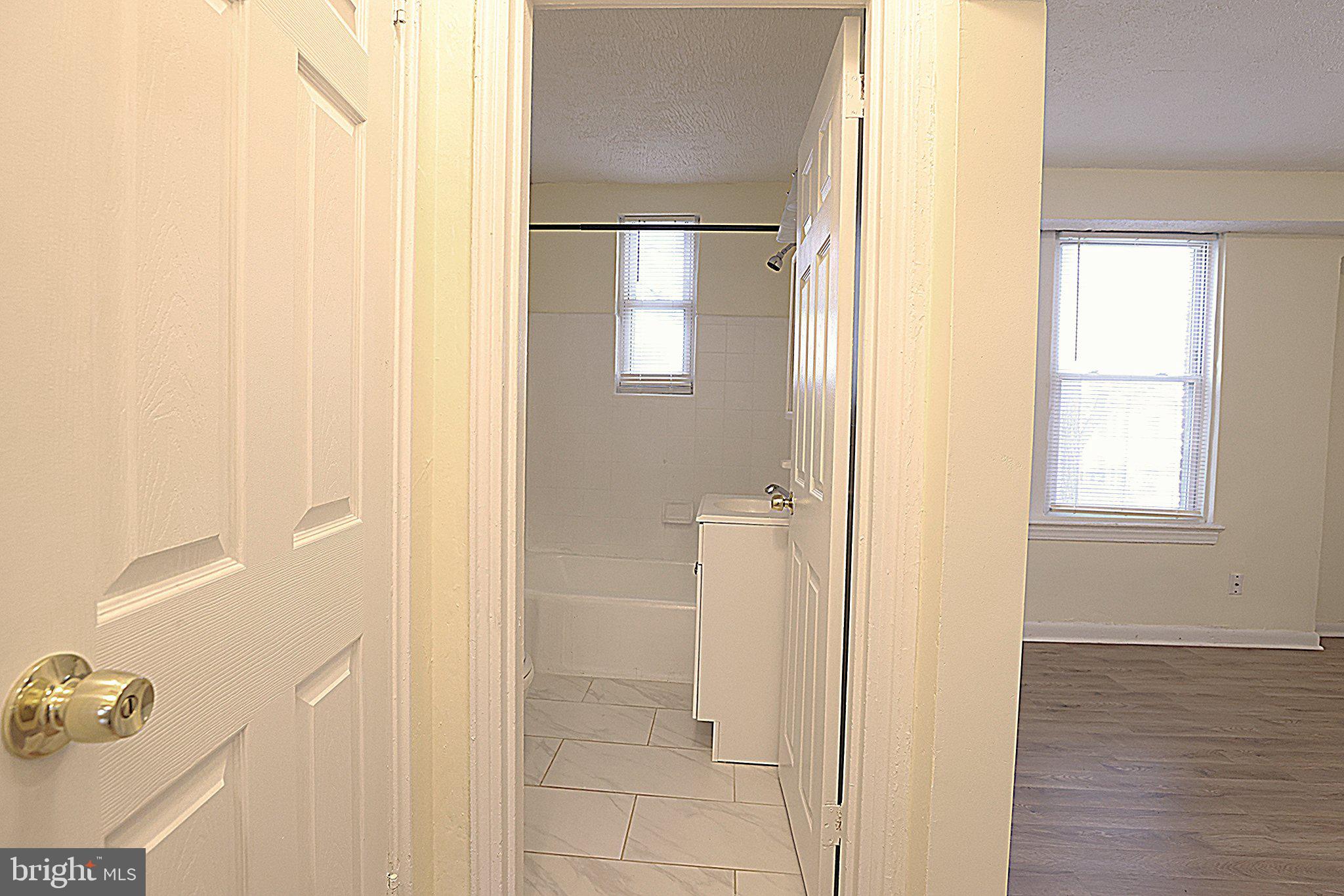 4329 Halley Terrace Southeast, Unit 3 Washington, DC 20032 - Photo 6 of 8 a view of empty room with wooden floor and cabinet