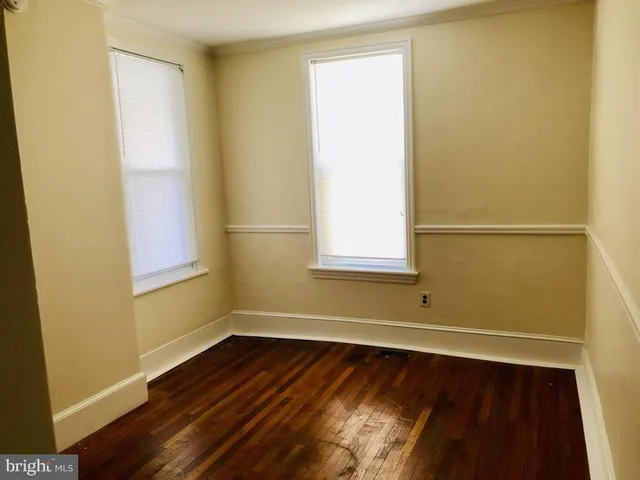 a view of a room with wooden floor and a window