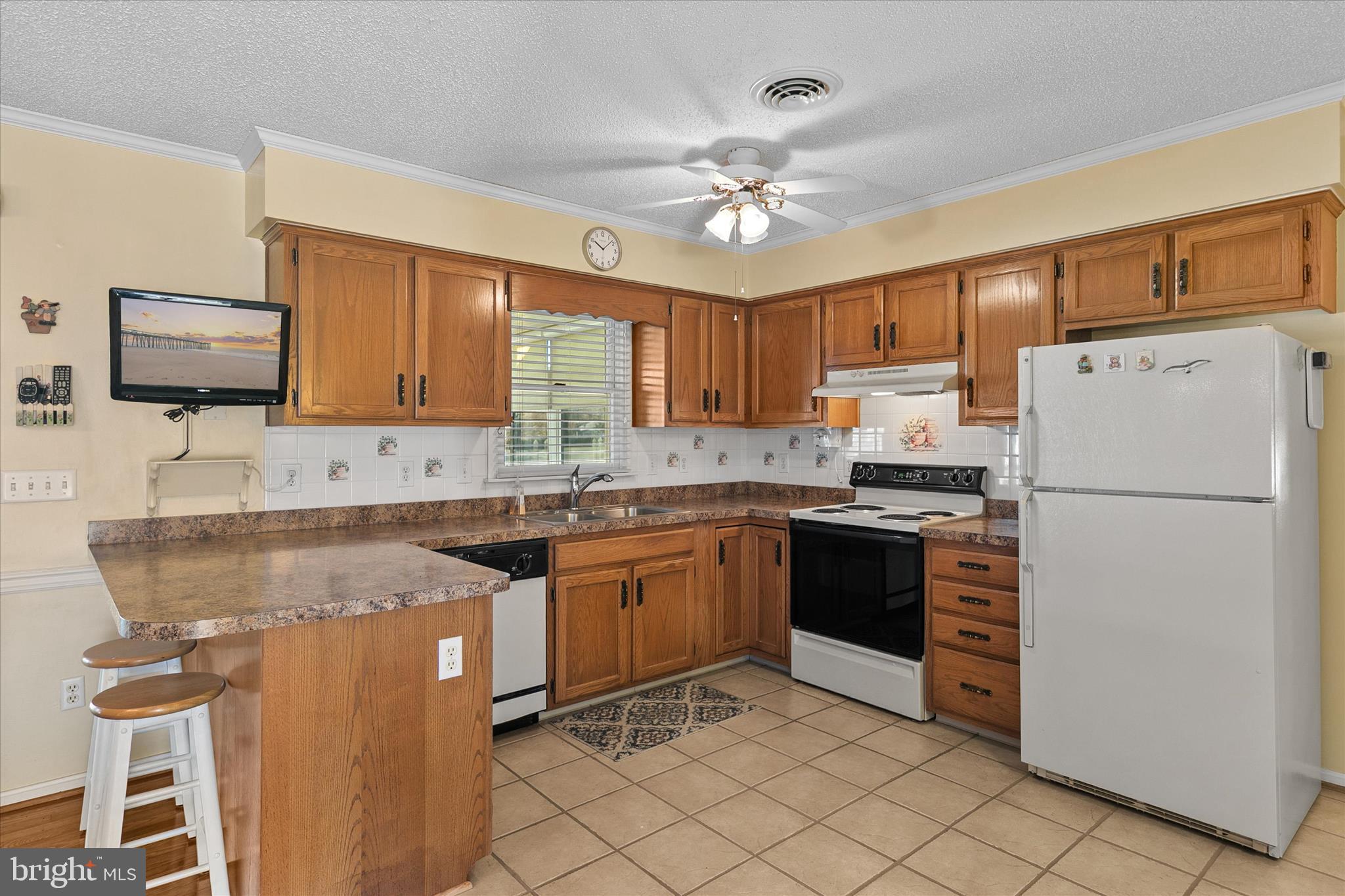 13 South Primrose Lane Ocean View, DE 19970 - Photo 12 of 38 a kitchen with granite countertop cabinets a sink a window and stainless steel appliances