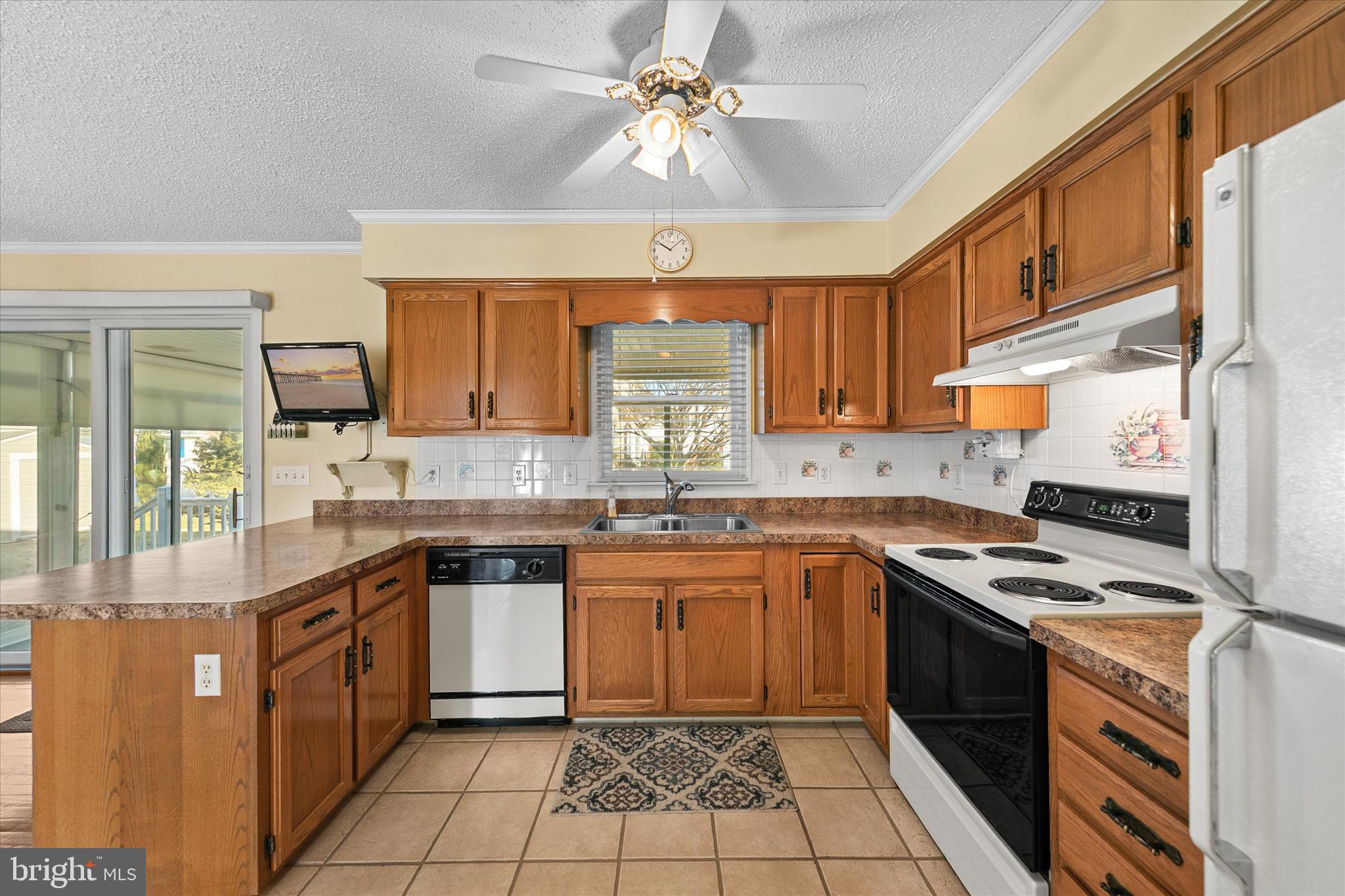 13 South Primrose Lane Ocean View, DE 19970 - Photo 13 of 38 a kitchen with a stove sink and cabinets