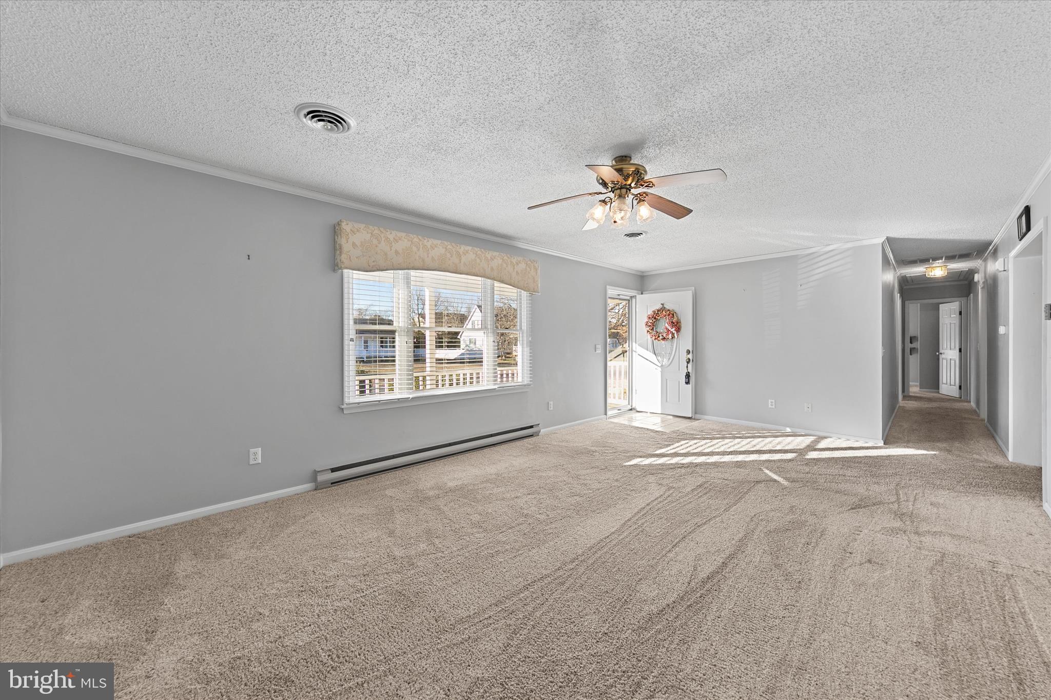 13 South Primrose Lane Ocean View, DE 19970 - Photo 5 of 38 an empty room with windows and ceiling fan view