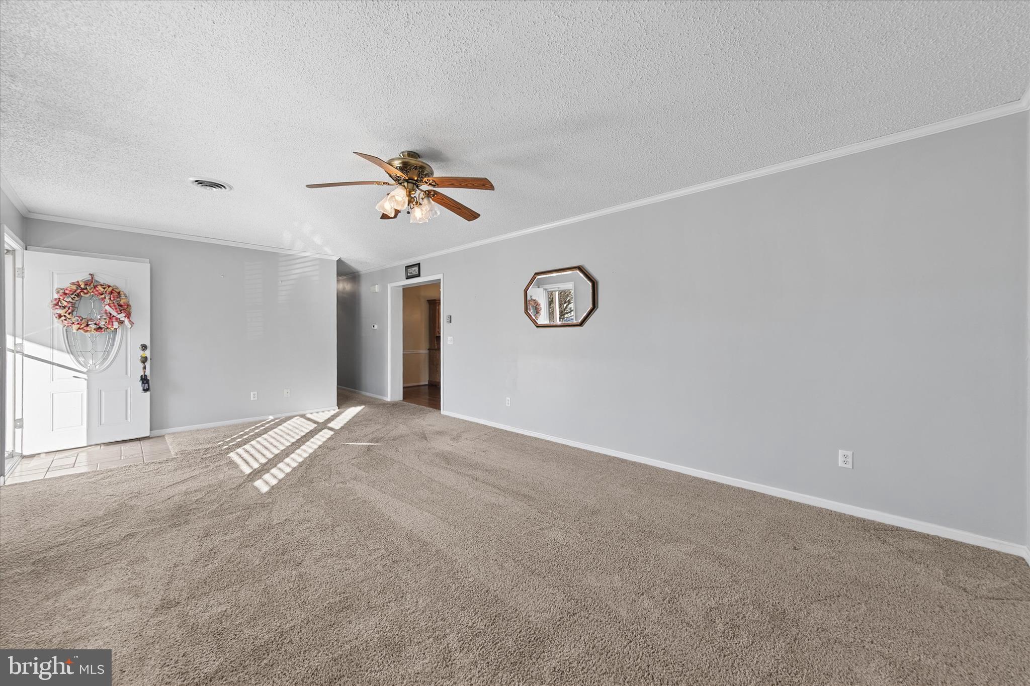 13 South Primrose Lane Ocean View, DE 19970 - Photo 6 of 38 a view of a livingroom with a ceiling fan and window