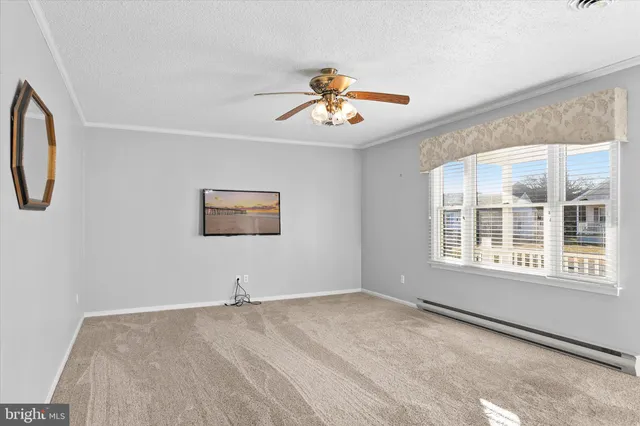 a view of a livingroom with a ceiling fan and window