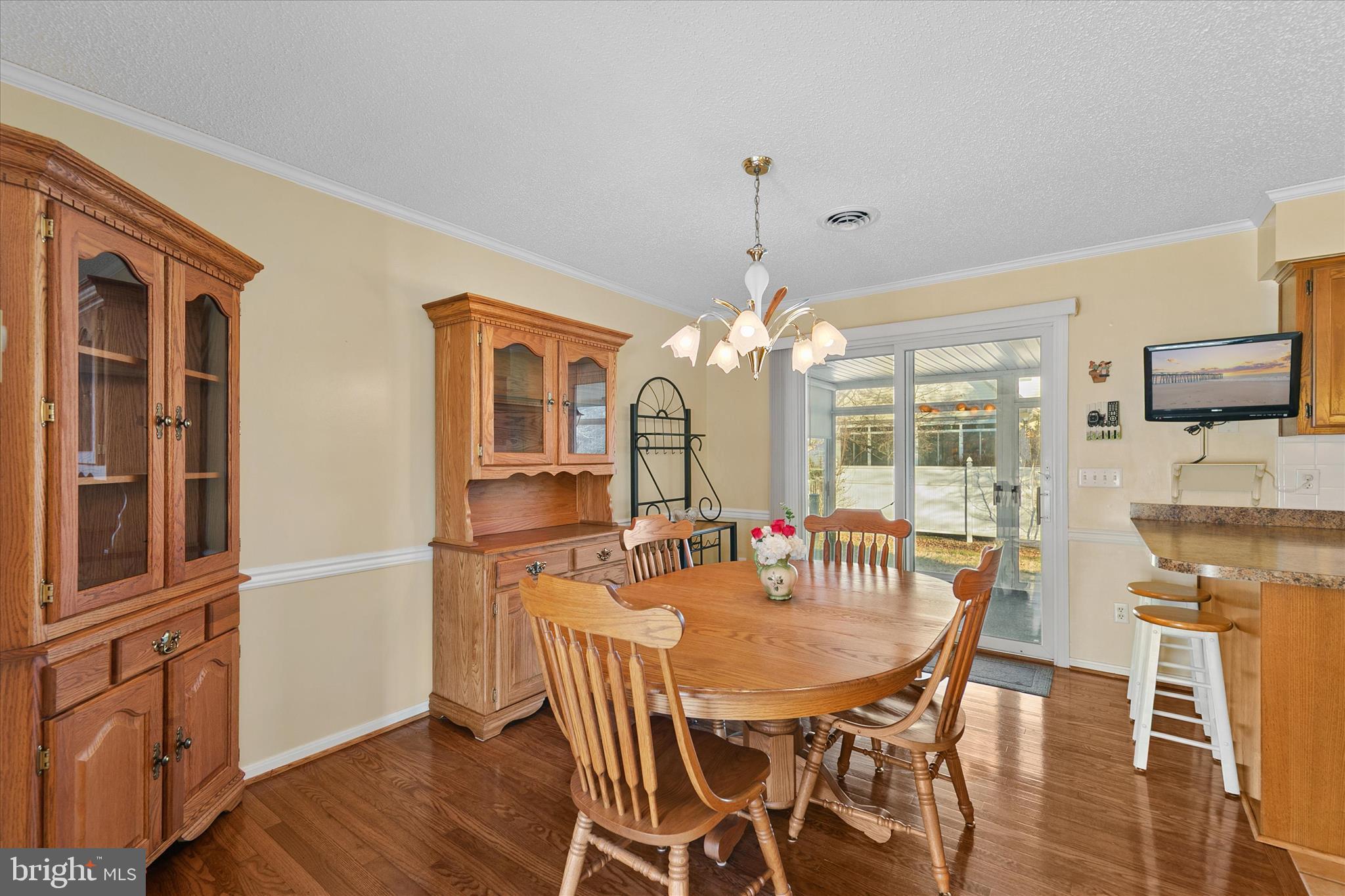 13 South Primrose Lane Ocean View, DE 19970 - Photo 9 of 38 a dining room with furniture a chandelier and wooden floor