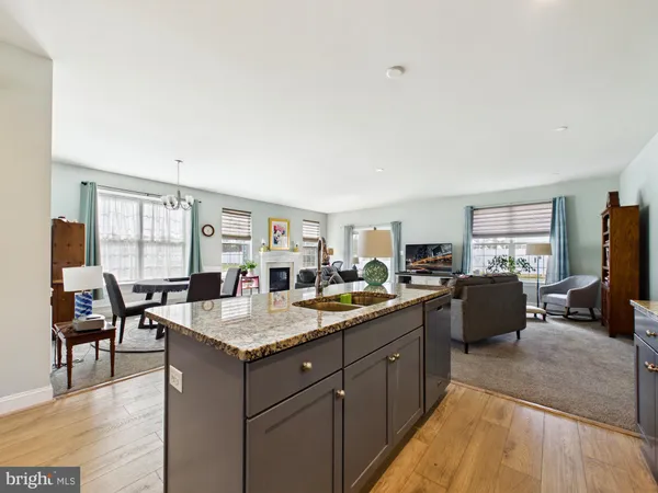 a kitchen with counter top space sink and living room