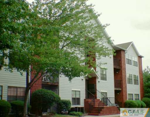 92 Keystone Court Edison, NJ 08817 - Photo 1 of 2 a front view of a house with a tree