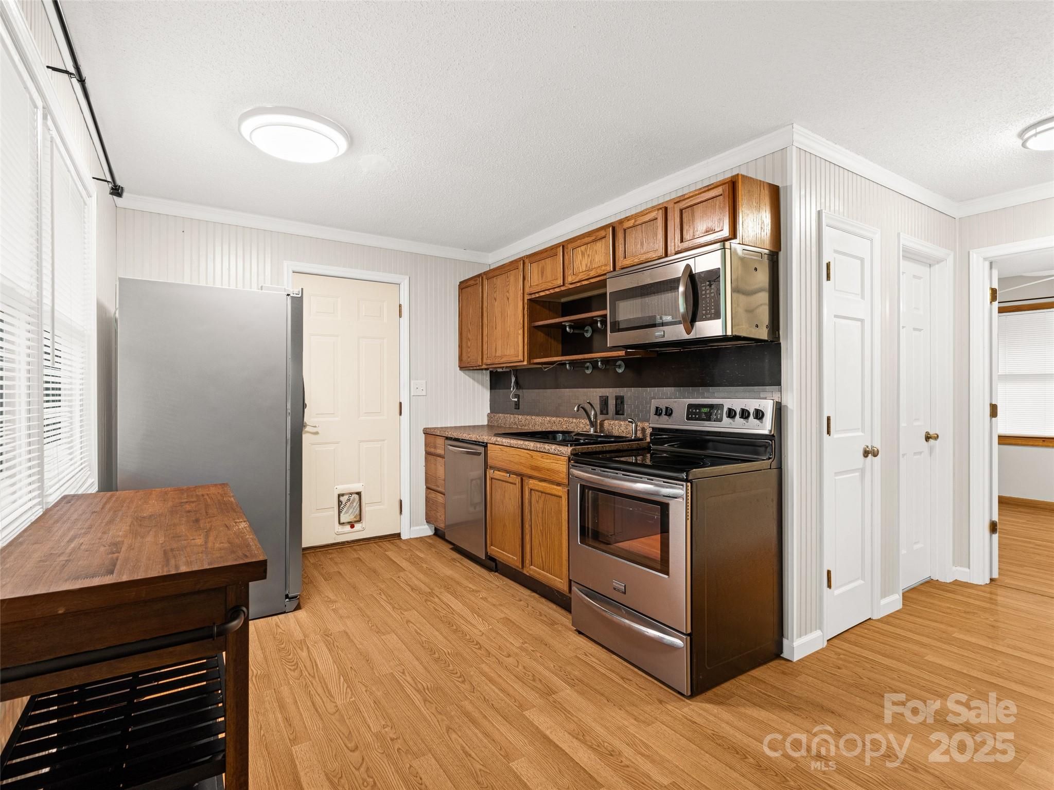 120 Wolf Pen Cove Road Brevard, NC 28712 - Photo 13 of 32 a kitchen with stainless steel appliances a stove and a refrigerator