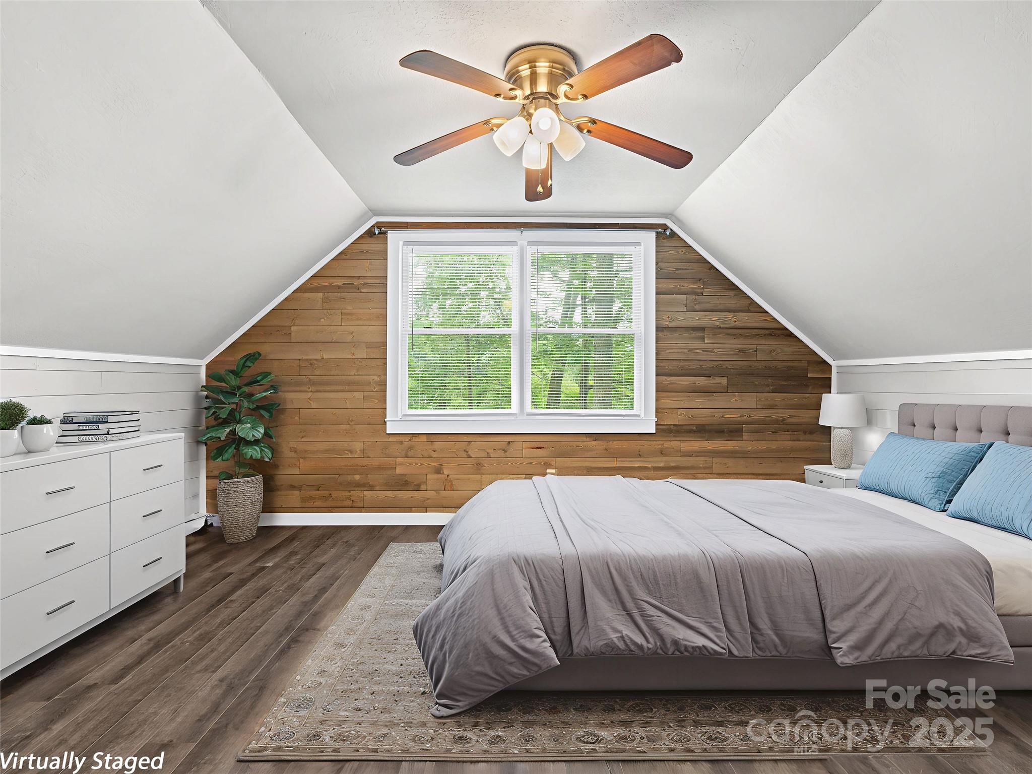 120 Wolf Pen Cove Road Brevard, NC 28712 - Photo 21 of 32 a bedroom with a bed and a chandelier