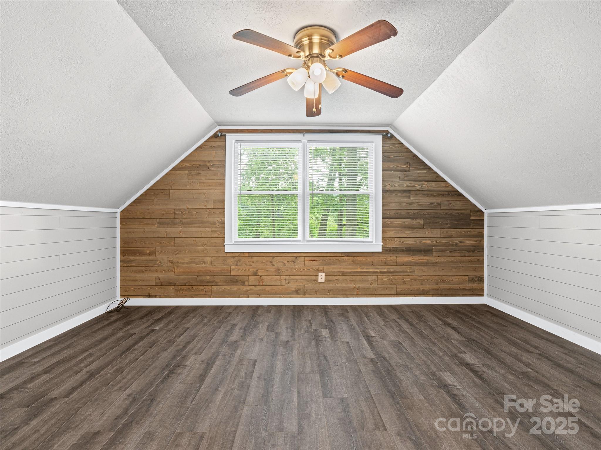 120 Wolf Pen Cove Road Brevard, NC 28712 - Photo 22 of 32 a view of an empty room with wooden floor and a window