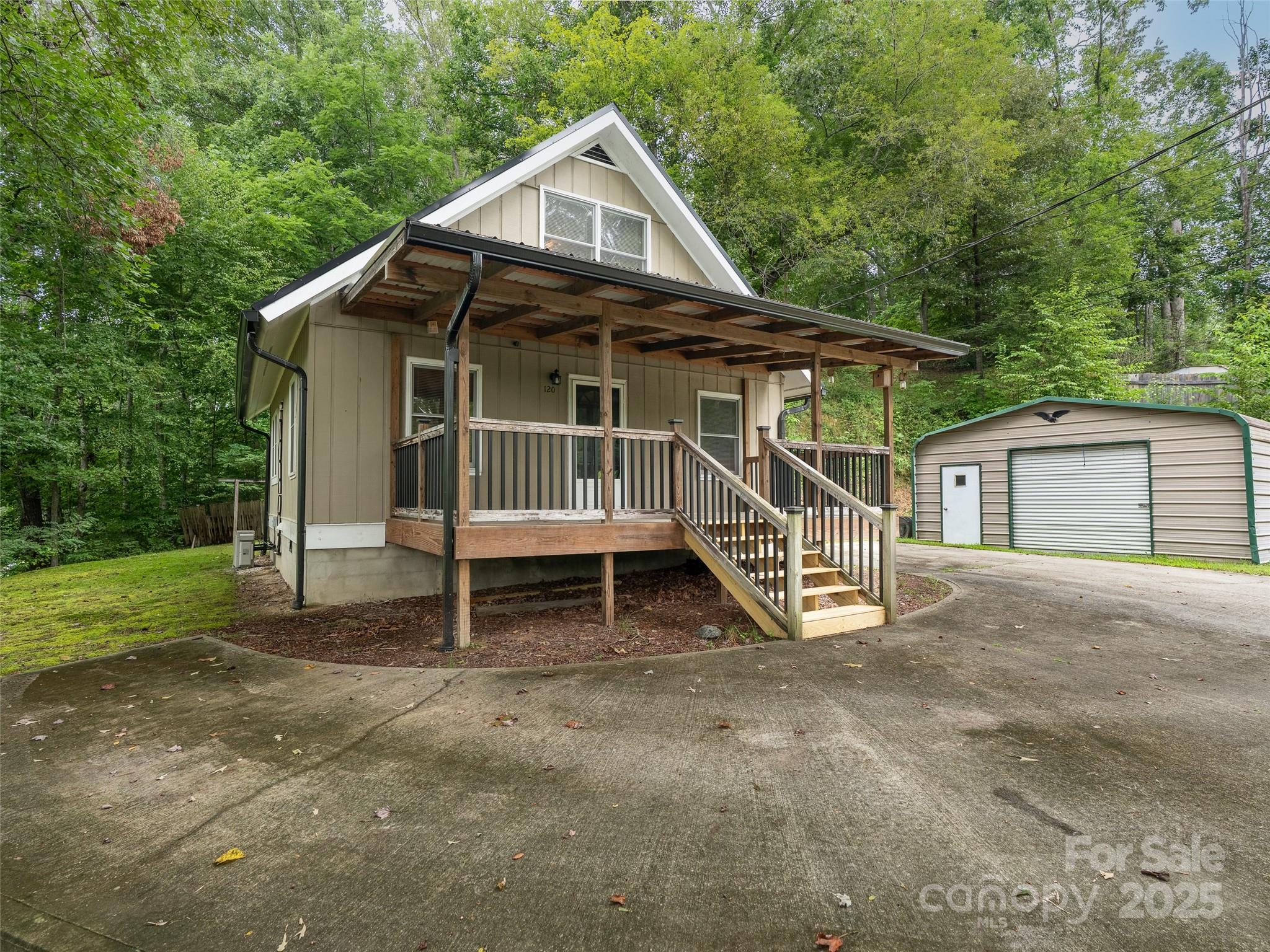 120 Wolf Pen Cove Road Brevard, NC 28712 - Photo 4 of 32 a house with tall trees in the background