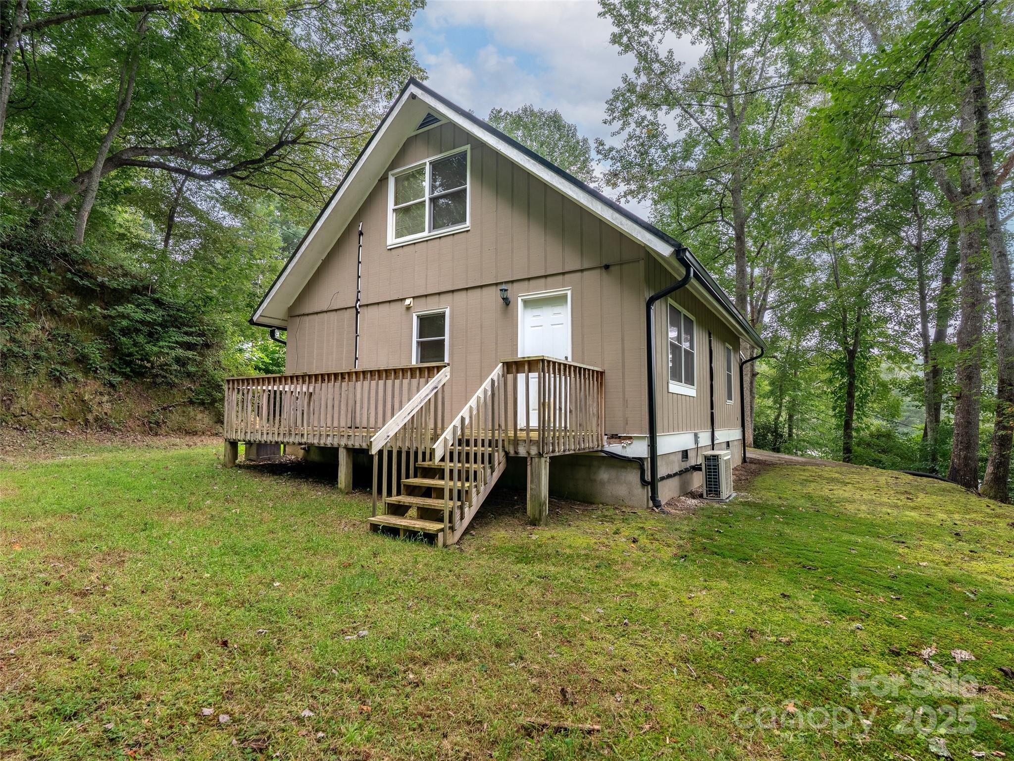 120 Wolf Pen Cove Road Brevard, NC 28712 - Photo 5 of 32 a view of a house with a yard and sitting area