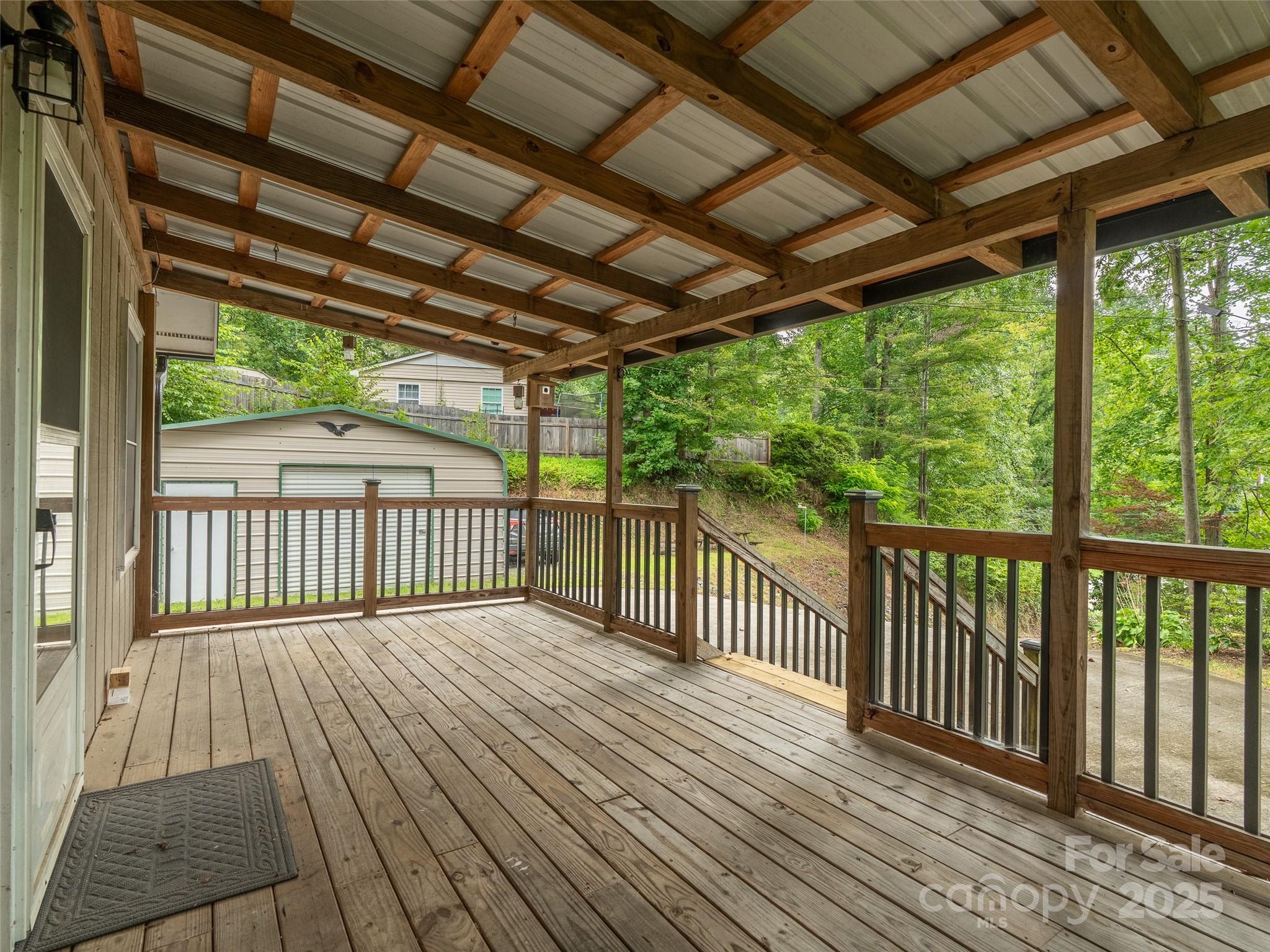 120 Wolf Pen Cove Road Brevard, NC 28712 - Photo 7 of 32 a view of a porch with wooden floor